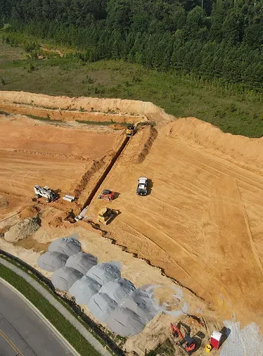 Aerial construction site preparation with earthmoving equipment